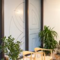 Icon die-cut for a full window frosting and chairs and plants in front of the interior windows.