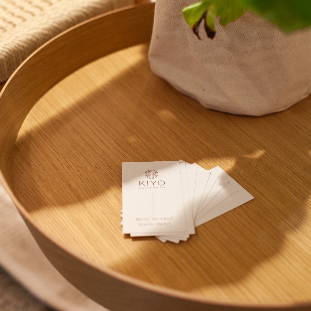 Custom business cards with modern sans serif font and sleek layout on a wooden tray.
