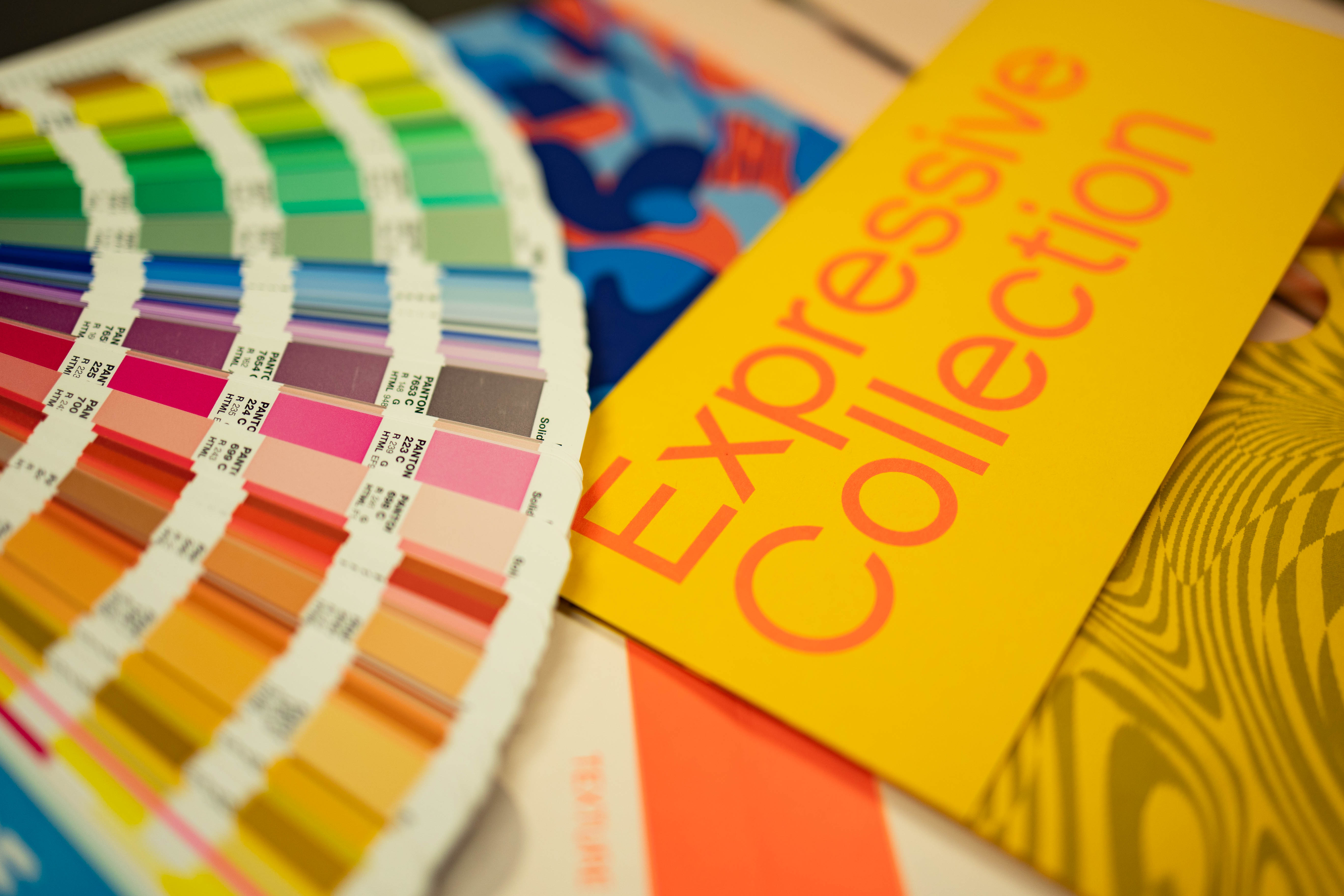 Close-up of colour swatches next to a bright yellow brochure titled "Expressive Collection"