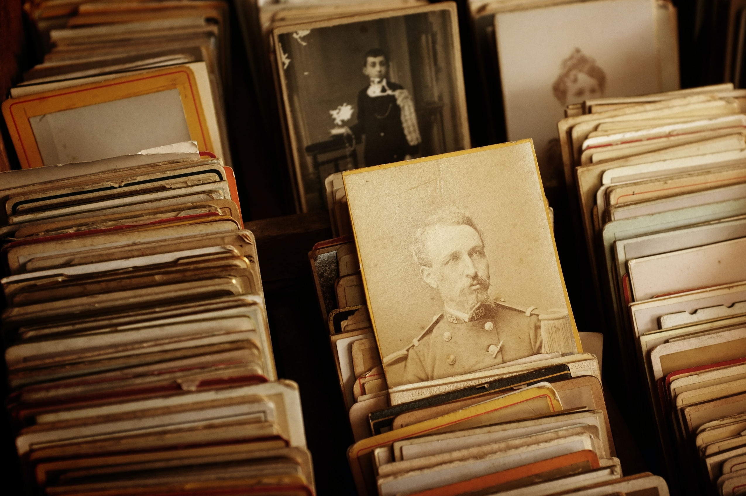Boxes of old photographs and a vintage photo of a soldier.