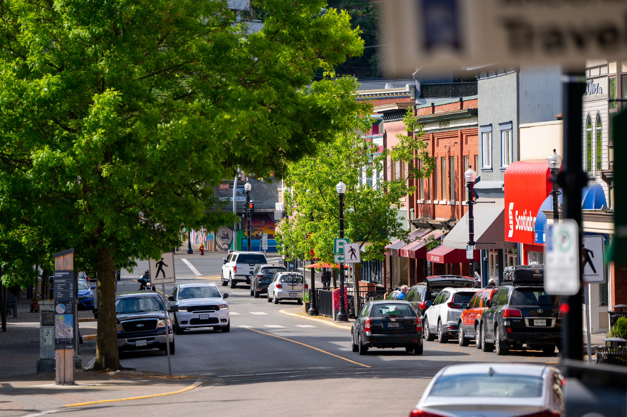 Downtown Nanaimo street view of shops, cars, and trees.
